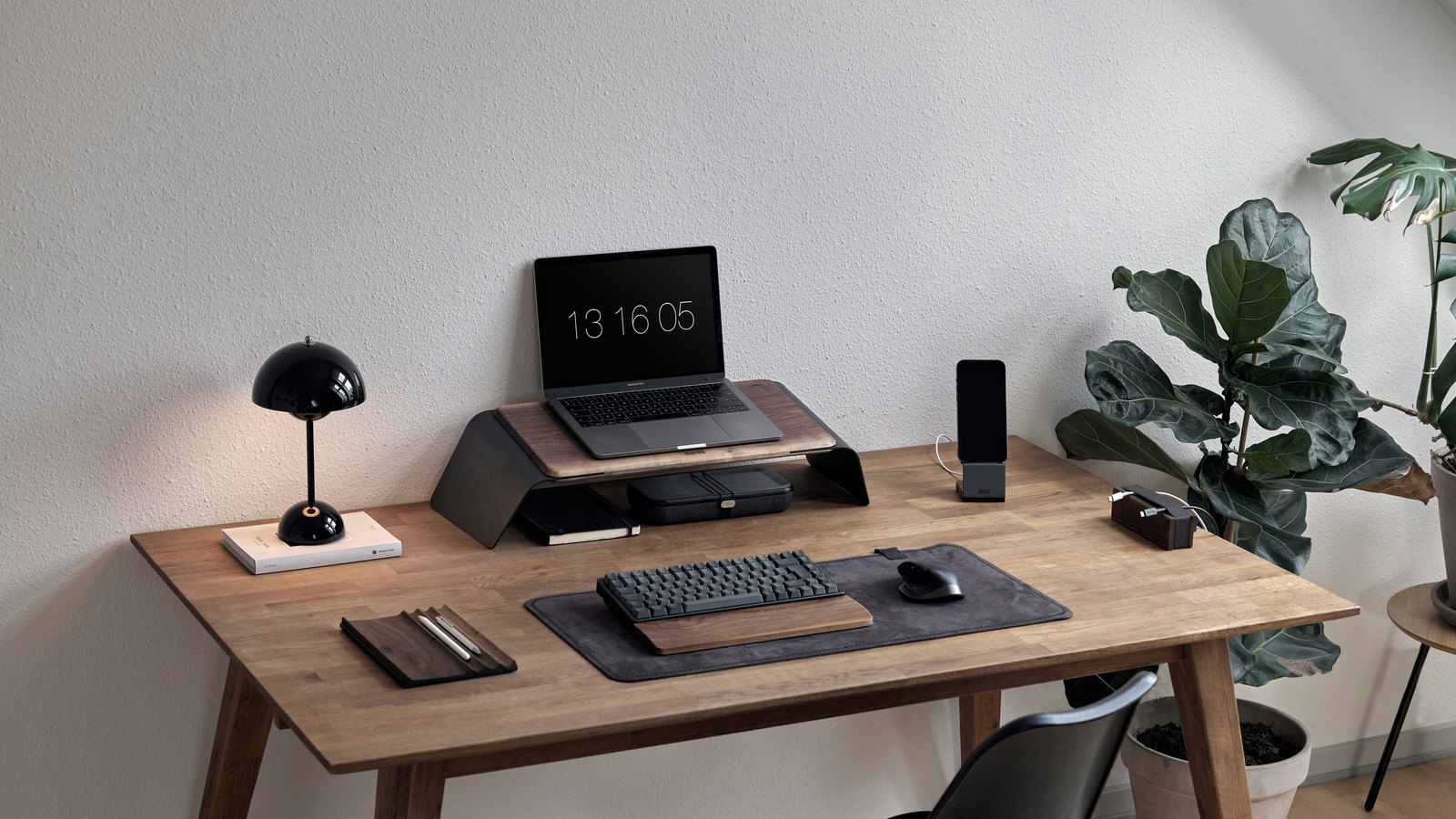 Laptop and desktop workspace on a wooden desk